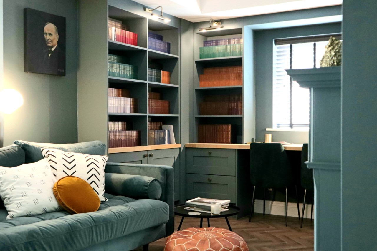 Bespoke library office painted to match wall colour of a light green almost olive colour.